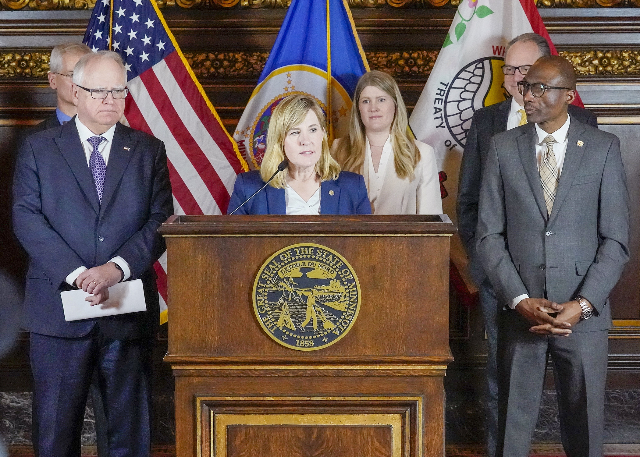 Flanked by Gov. Tim Walz and Senate President Bobby Joe Champion, House Speaker Melissa Hortman announces an agreement on budget targets March 21. (Photo by Andrew VonBank)